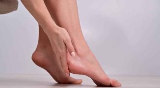 Close-up of female feet. Woman moisturizes heels with cream